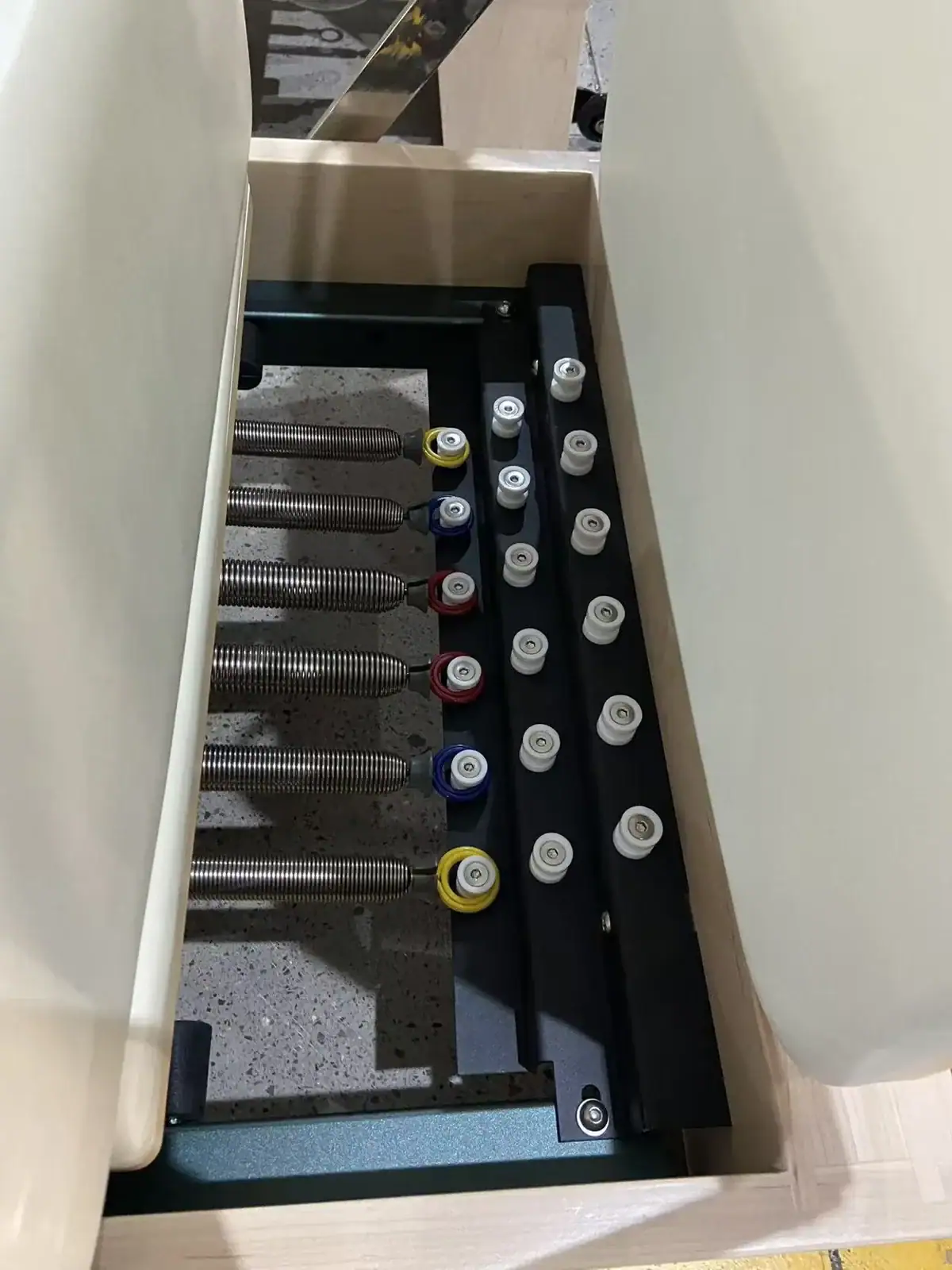 Color-coded WD-MS-003 reformer springs and spring bar during factory inspection