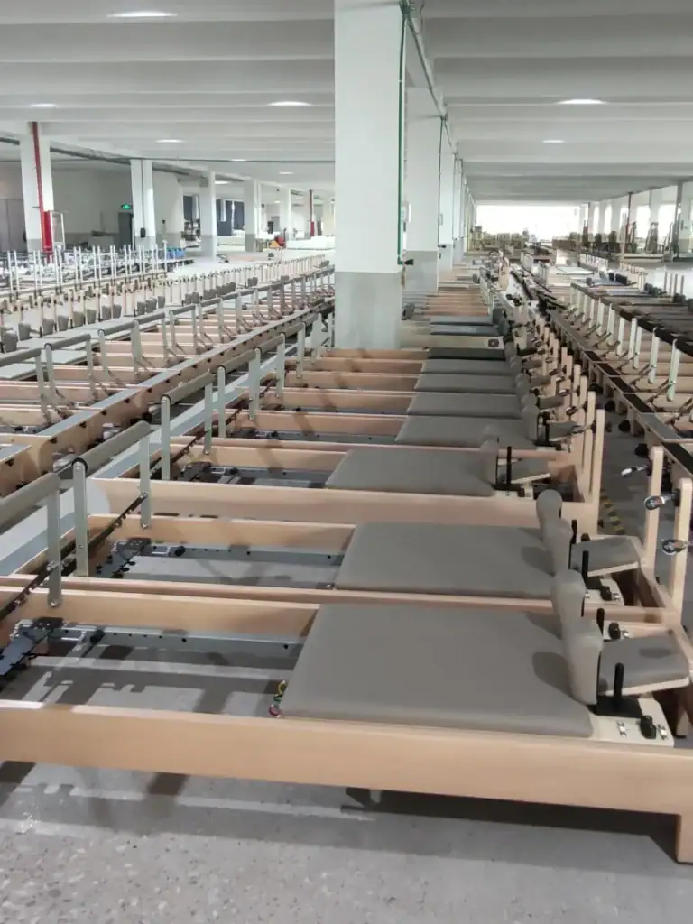 Wholesale buyer reviewing Pilates equipment with the P.E.Pilates team