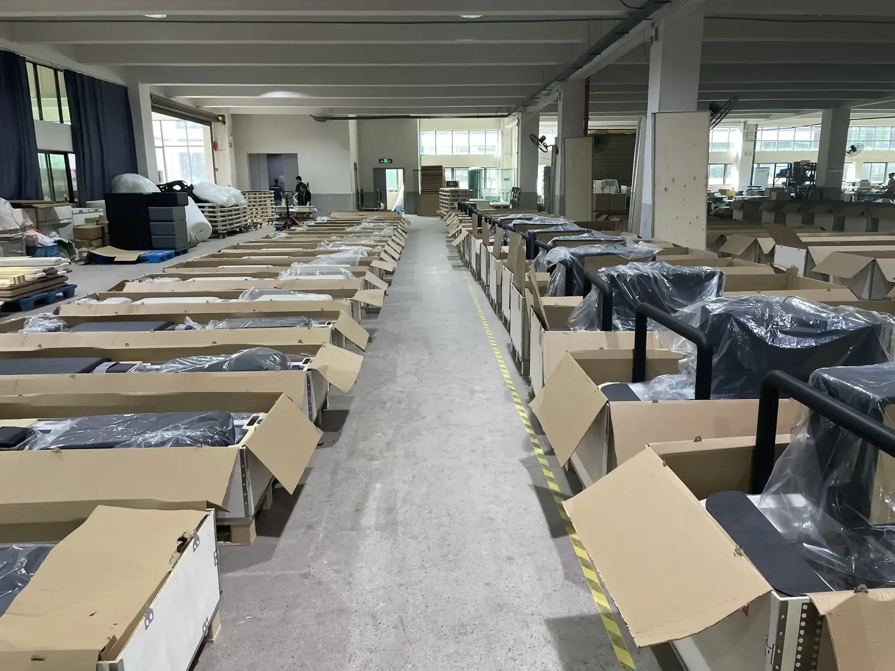 Bulk Pilates reformers protected and organized before export packing.