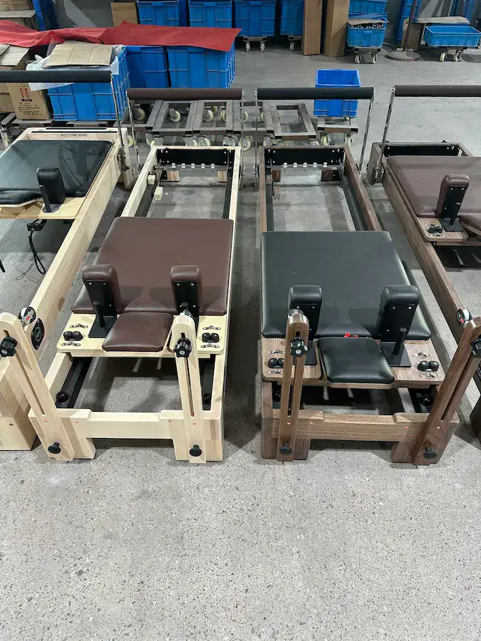 Pilates reformers arranged in production for batch consistency checks