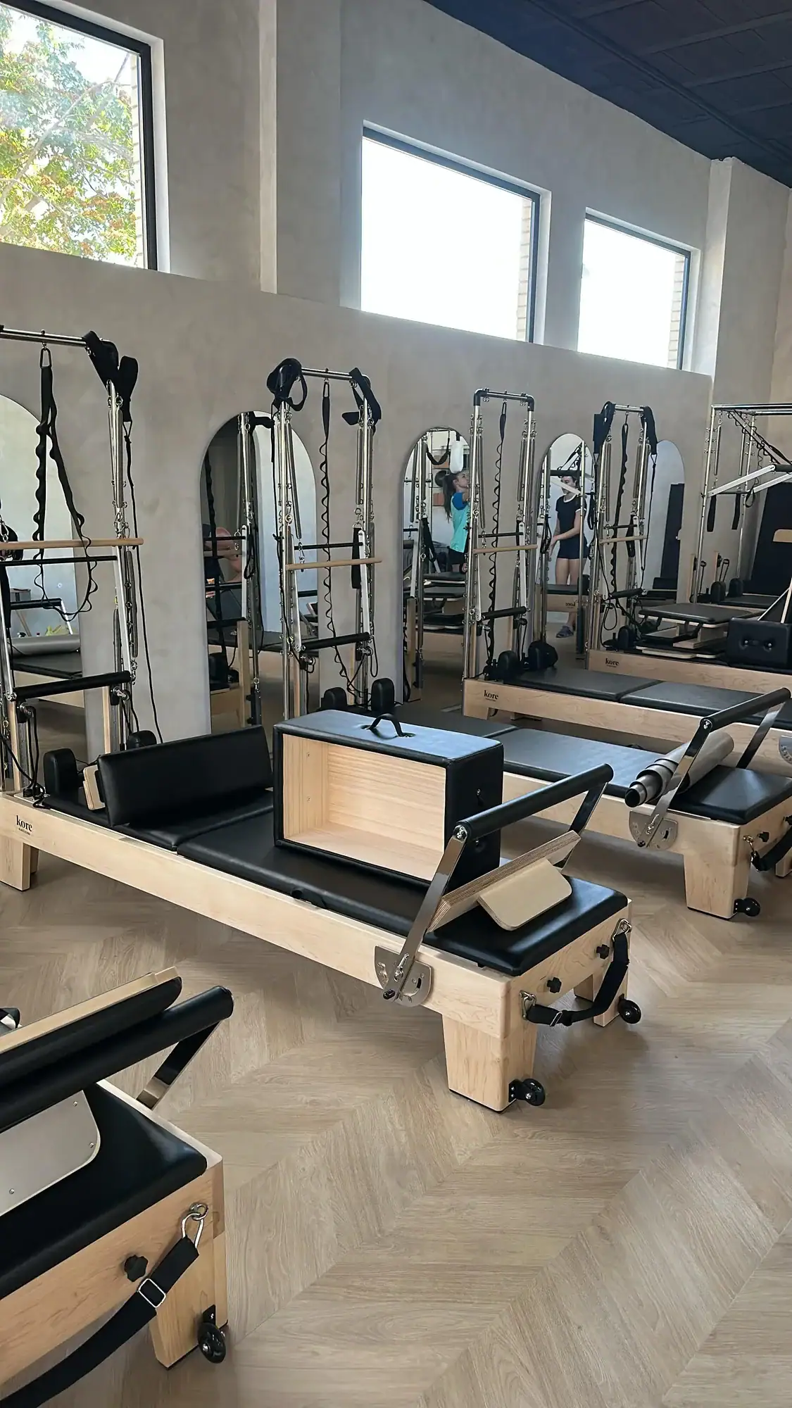 Reformers with towers arranged in a Spanish Pilates studio
