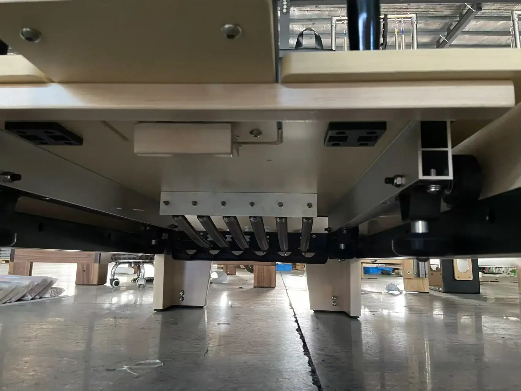 Undercarriage inspection on a WD-MS-003 maple Pilates reformer
