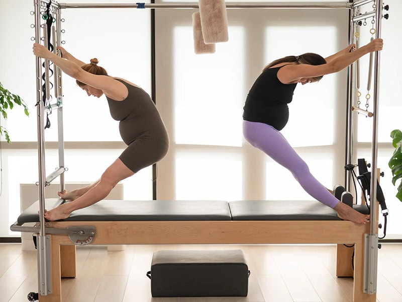 Pilates Cadillac machine with tower and trapeze table