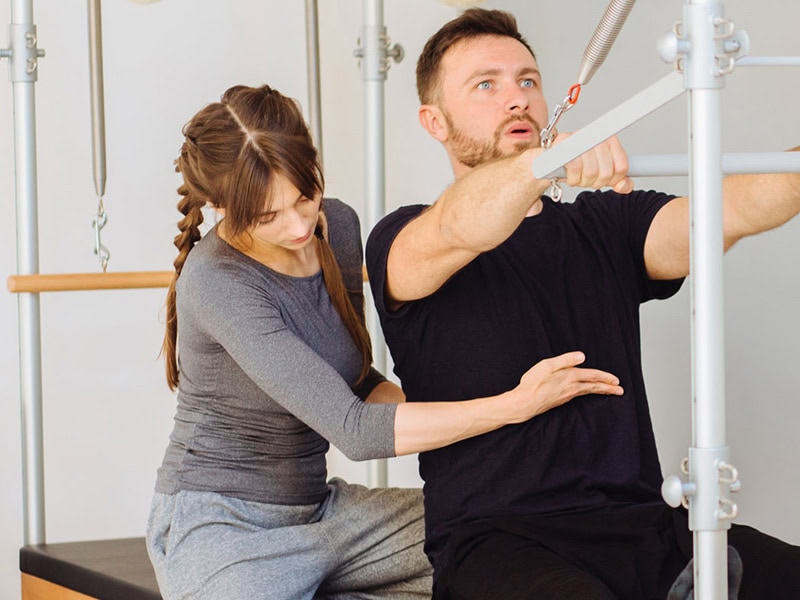 Pilates Cadillac machine with tower and trapeze table